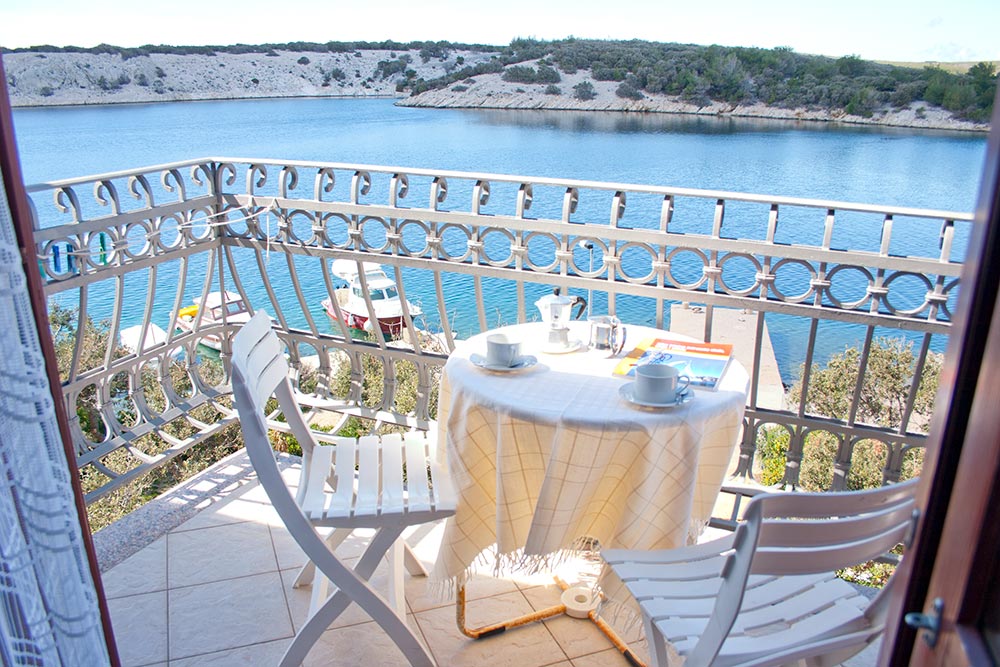 Balcony of Apartment S3-A with seating and view toward Simuni
