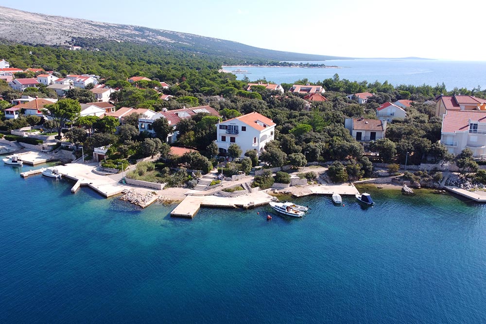 Aerial view of Apartments Simuni 66 on Pag Island, showing the seafront location next to Simuni bay