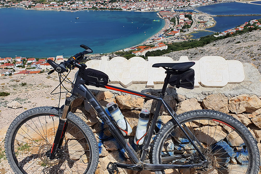 Cycling with a view over the town of Pag.